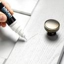Applying touch-up paint to a white kitchen cabinet using a touch-up pen